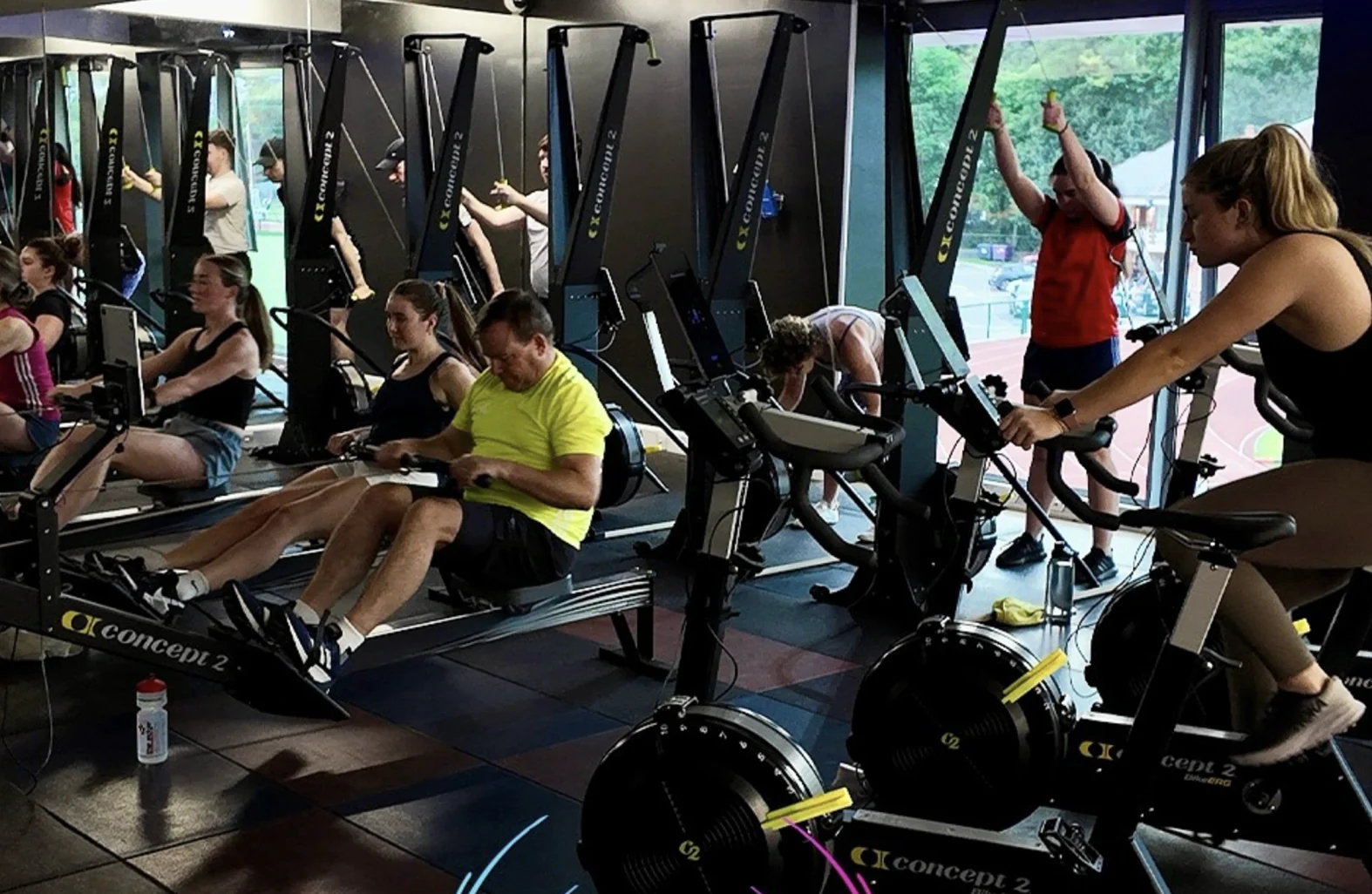 A group training on rowers and exercise bikes